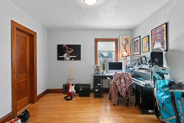 office space with baseboards and wood finished floors