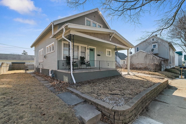 view of front facade with a porch and fence