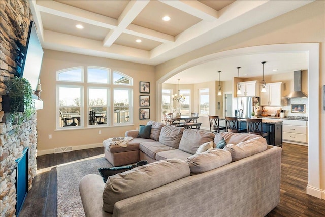 living room with visible vents, beamed ceiling, a fireplace, dark wood-style floors, and coffered ceiling