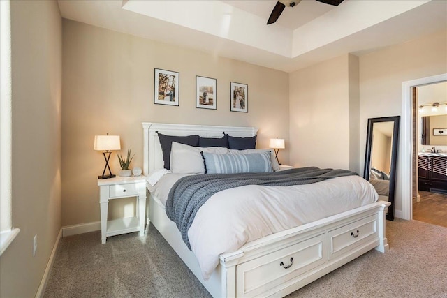 carpeted bedroom featuring baseboards, a ceiling fan, and ensuite bathroom