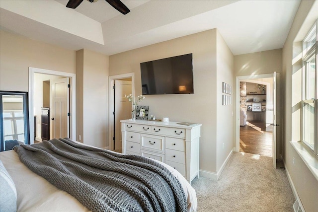 bedroom with light colored carpet and baseboards