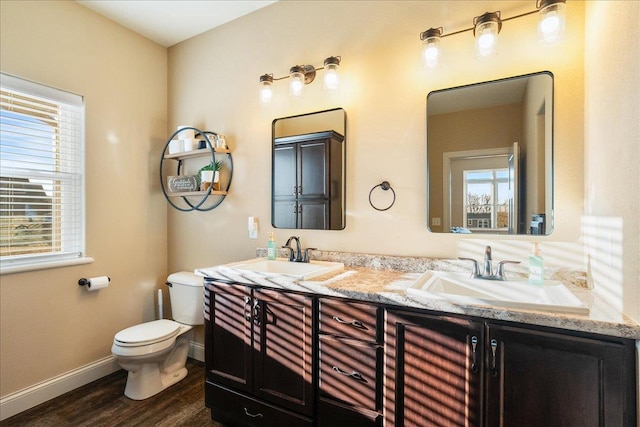 full bathroom featuring toilet, plenty of natural light, and a sink