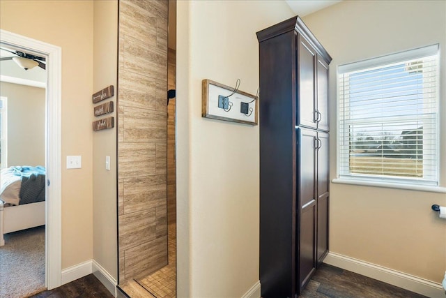 hallway with baseboards and dark wood-style floors