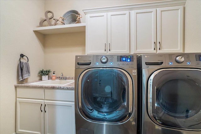 laundry area with a sink, cabinet space, and washing machine and clothes dryer