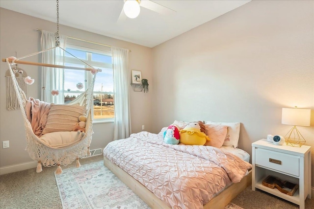 carpeted bedroom with baseboards and a ceiling fan