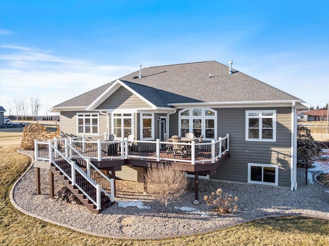 back of property featuring stairway, roof with shingles, and a wooden deck