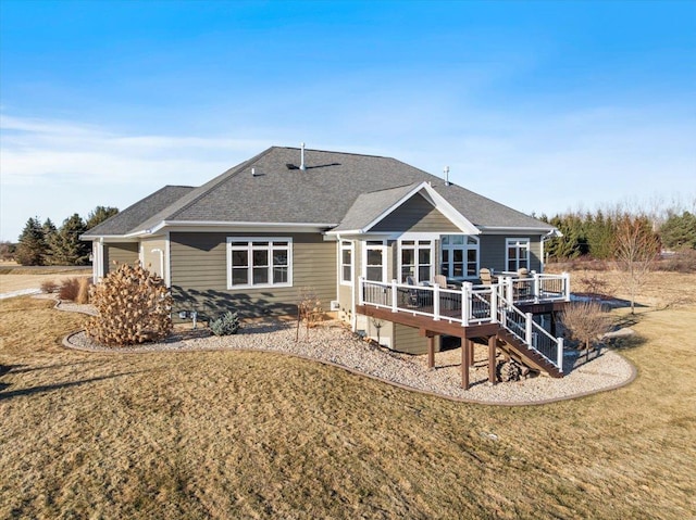 back of house with a yard, stairway, a shingled roof, and a deck