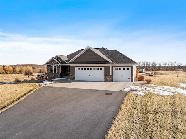 craftsman inspired home with stone siding, a garage, and driveway