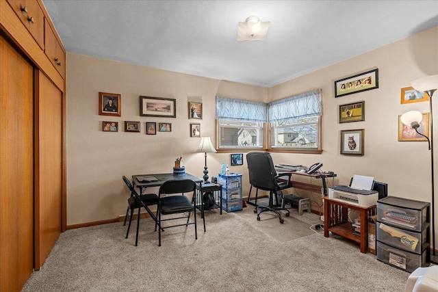 office area with baseboards and light carpet