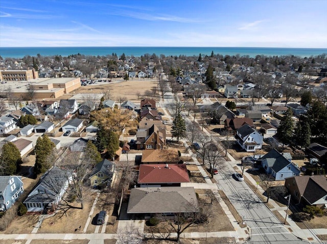 drone / aerial view with a water view and a residential view