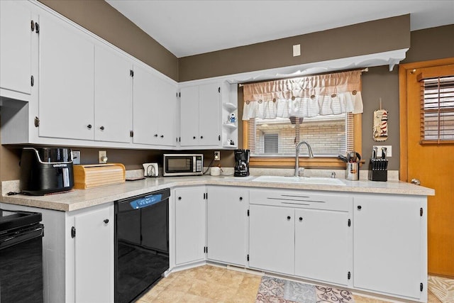 kitchen with stainless steel microwave, dishwasher, light countertops, white cabinets, and a sink