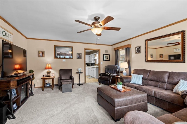 living room featuring light colored carpet, baseboards, crown molding, and a ceiling fan