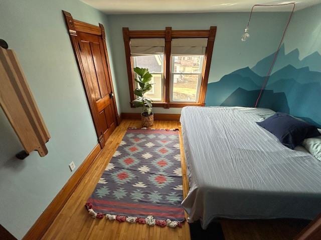 bedroom featuring light wood-style flooring and baseboards