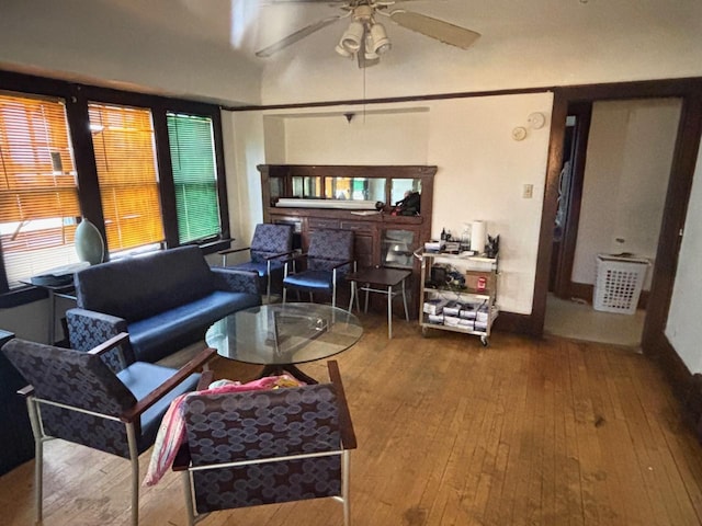 living area featuring wood-type flooring and ceiling fan