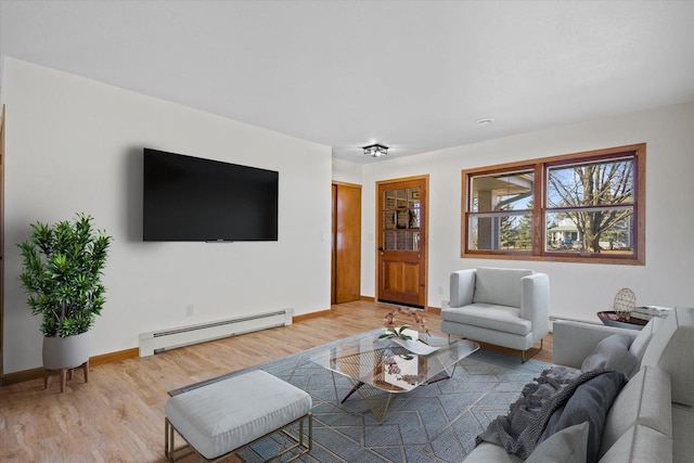 living area with baseboards, baseboard heating, and light wood finished floors