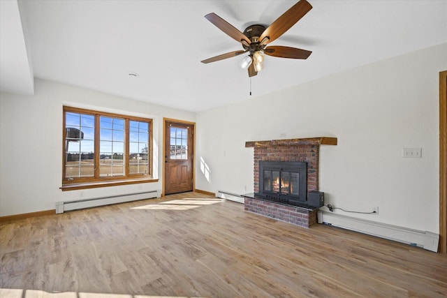 unfurnished living room with a baseboard heating unit, baseboard heating, wood finished floors, and a fireplace