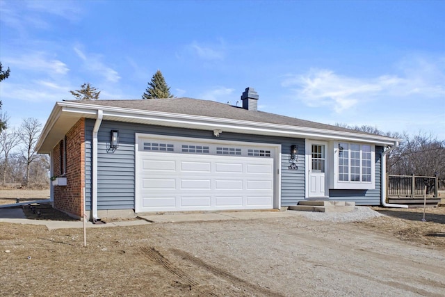 ranch-style home with driveway, a shingled roof, a chimney, a garage, and brick siding