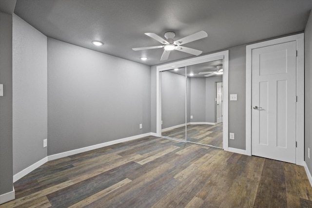 unfurnished bedroom with wood finished floors, baseboards, a closet, and ceiling fan