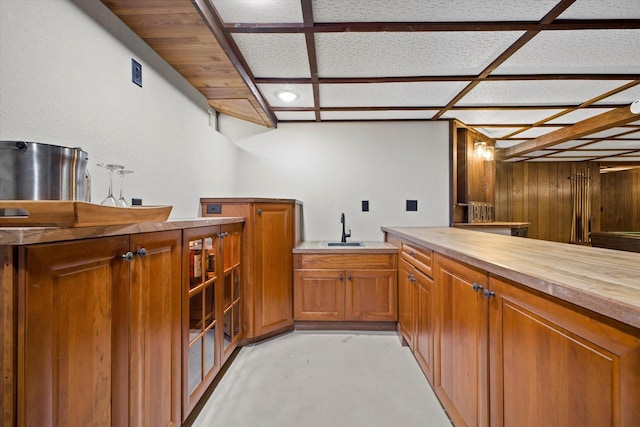 bar featuring finished concrete floors and a sink