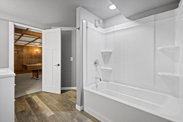 full bathroom featuring vanity, bathing tub / shower combination, wood finished floors, and baseboards