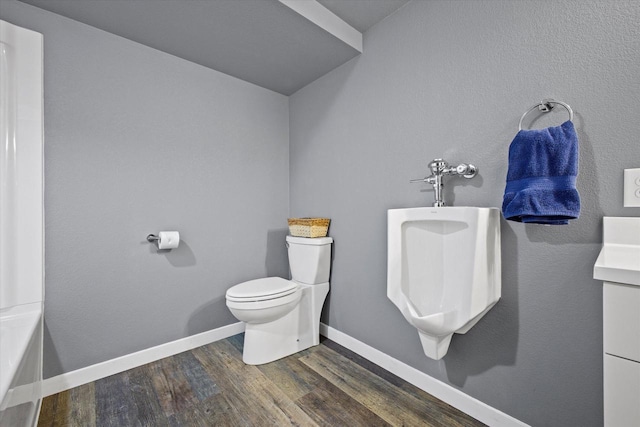 bathroom with baseboards, toilet, and wood finished floors