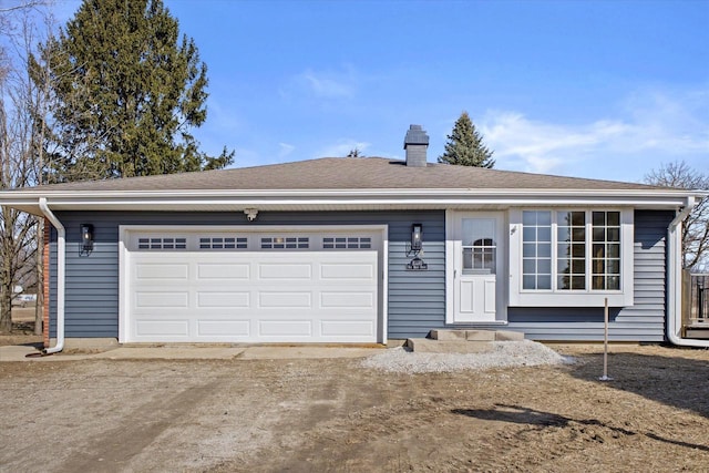 ranch-style home with roof with shingles, an attached garage, driveway, and a chimney