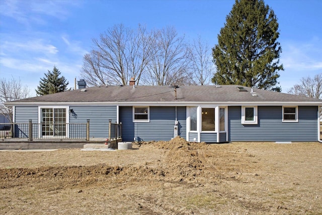 rear view of property with a shingled roof