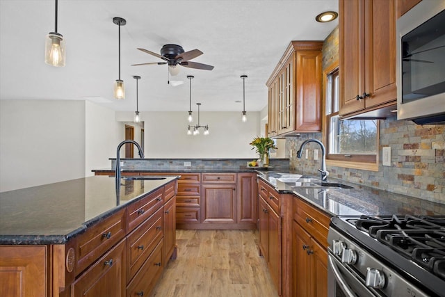 kitchen featuring a sink, stainless steel appliances, and brown cabinets