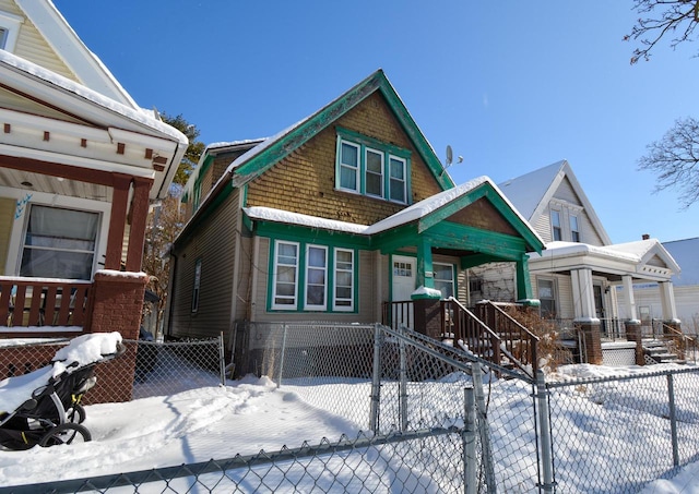 view of front facade featuring a fenced front yard and a porch