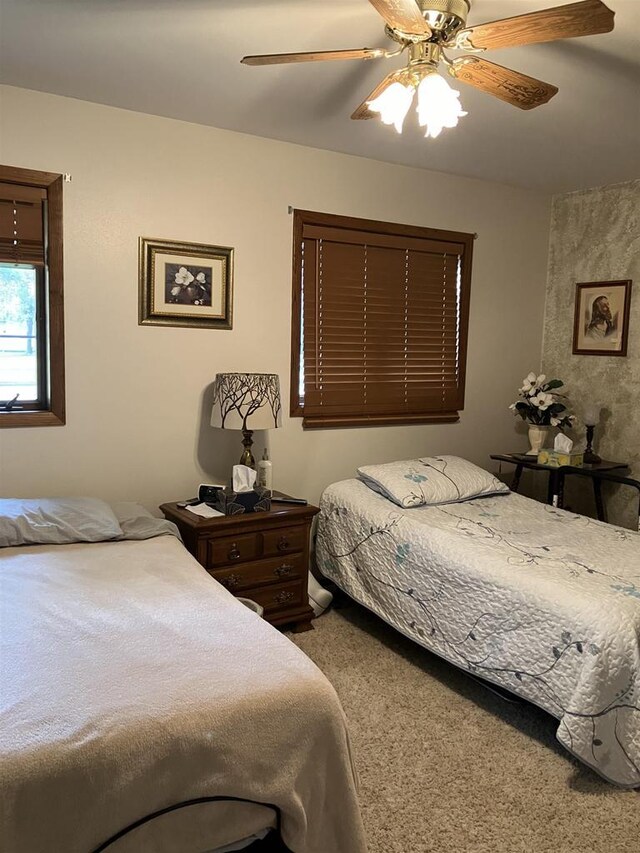 carpeted bedroom featuring a ceiling fan