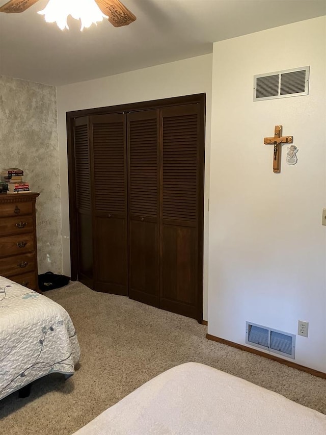 bedroom featuring visible vents, carpet floors, a closet, and ceiling fan