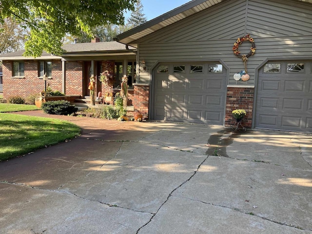 view of front of property with brick siding, concrete driveway, and a garage