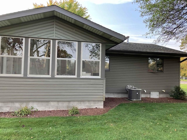 view of property exterior featuring cooling unit and a yard