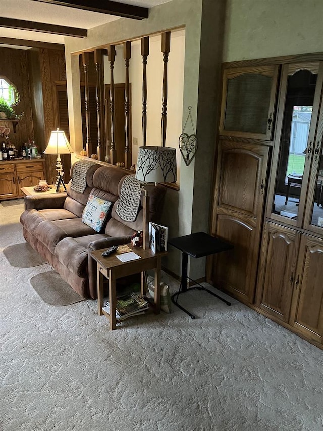 living room with beam ceiling and carpet flooring