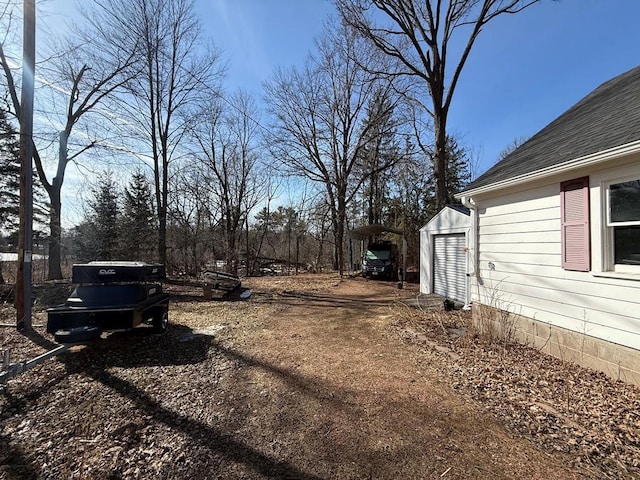 view of yard with a carport and driveway