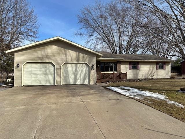 ranch-style home with an attached garage and driveway