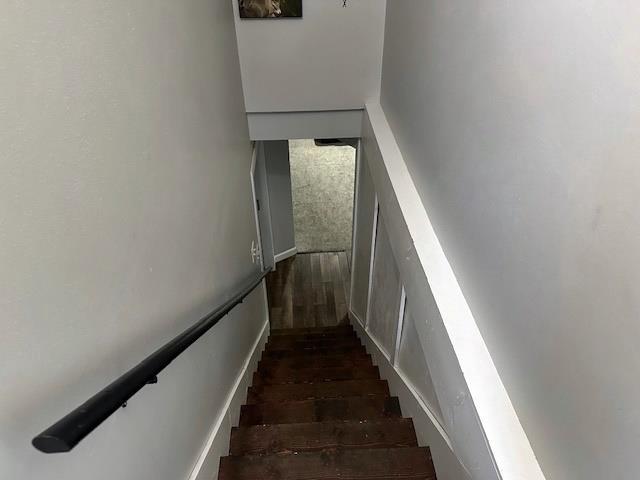 stairway featuring wood finished floors