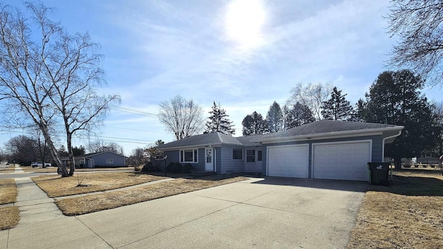 single story home with concrete driveway and an attached garage