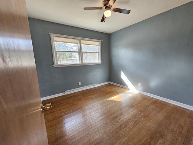 empty room featuring a baseboard radiator, baseboards, ceiling fan, and hardwood / wood-style flooring