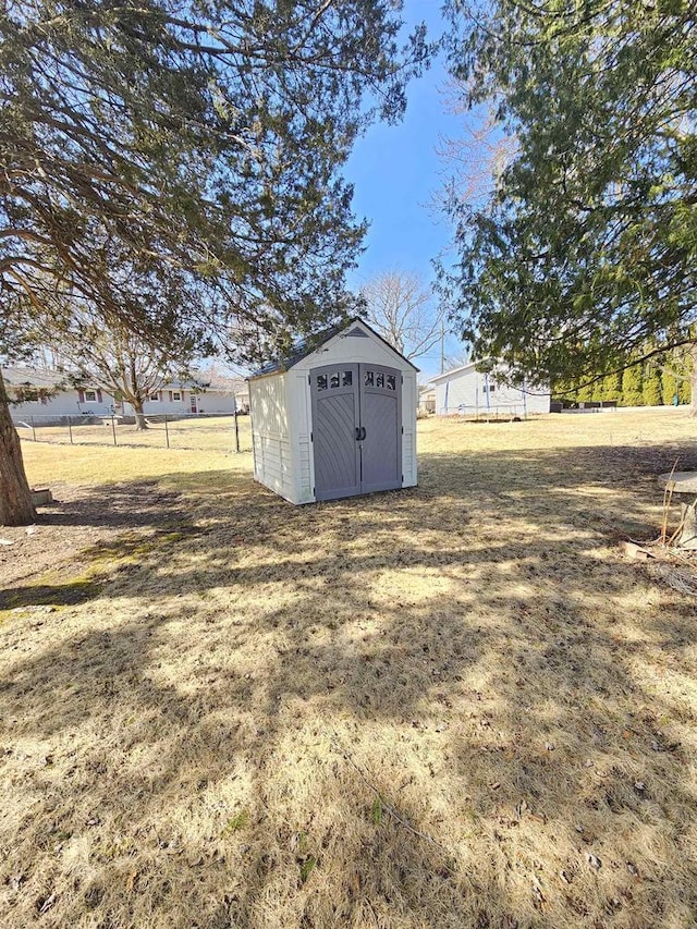 view of shed featuring fence