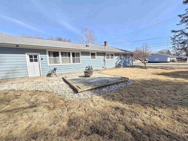 back of property featuring a lawn and a chimney