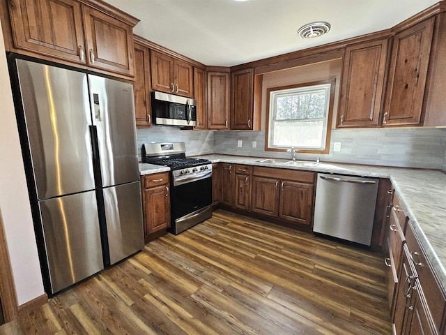 kitchen featuring visible vents, dark wood finished floors, light countertops, appliances with stainless steel finishes, and a sink