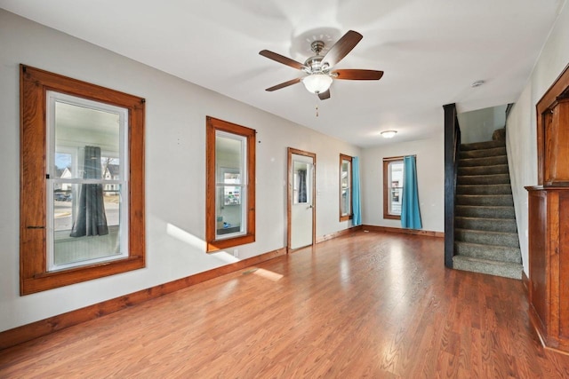 entrance foyer featuring stairs, wood finished floors, baseboards, and a ceiling fan