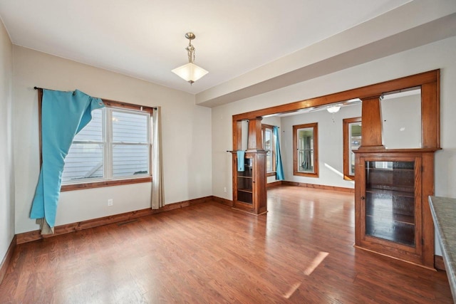 interior space featuring visible vents, wood finished floors, and baseboards