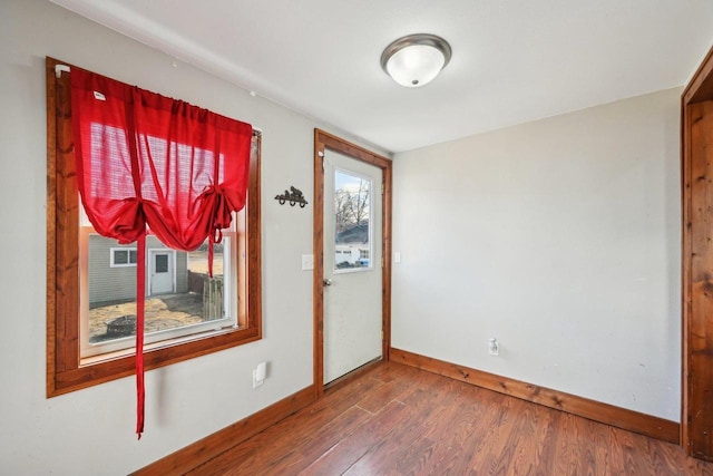 unfurnished room featuring wood finished floors and baseboards