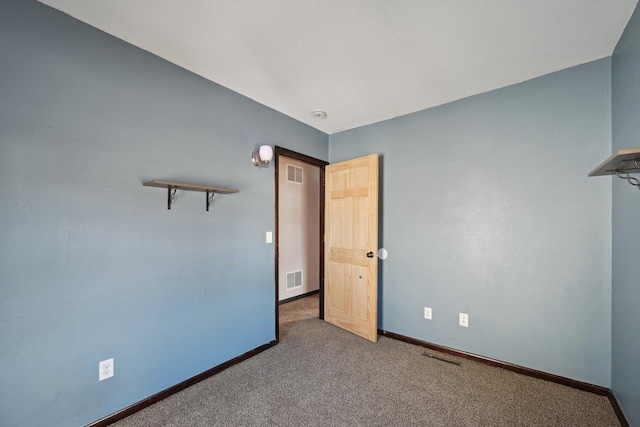 empty room with visible vents, carpet flooring, and baseboards