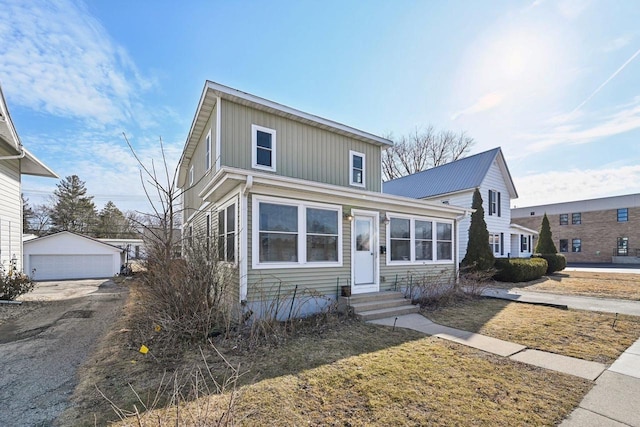 traditional home featuring a garage, an outbuilding, and entry steps