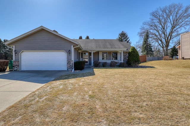 ranch-style home featuring a front lawn, fence, covered porch, concrete driveway, and an attached garage