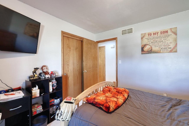 bedroom featuring a closet and visible vents