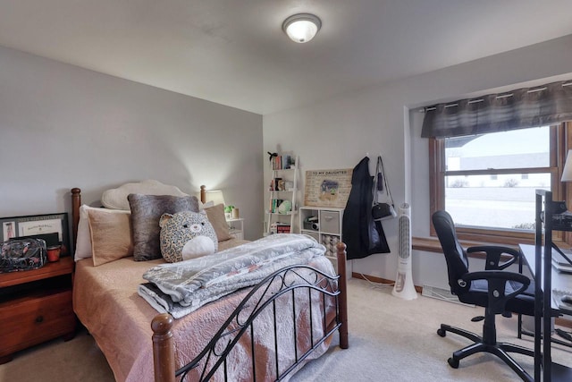 bedroom with light colored carpet and baseboards